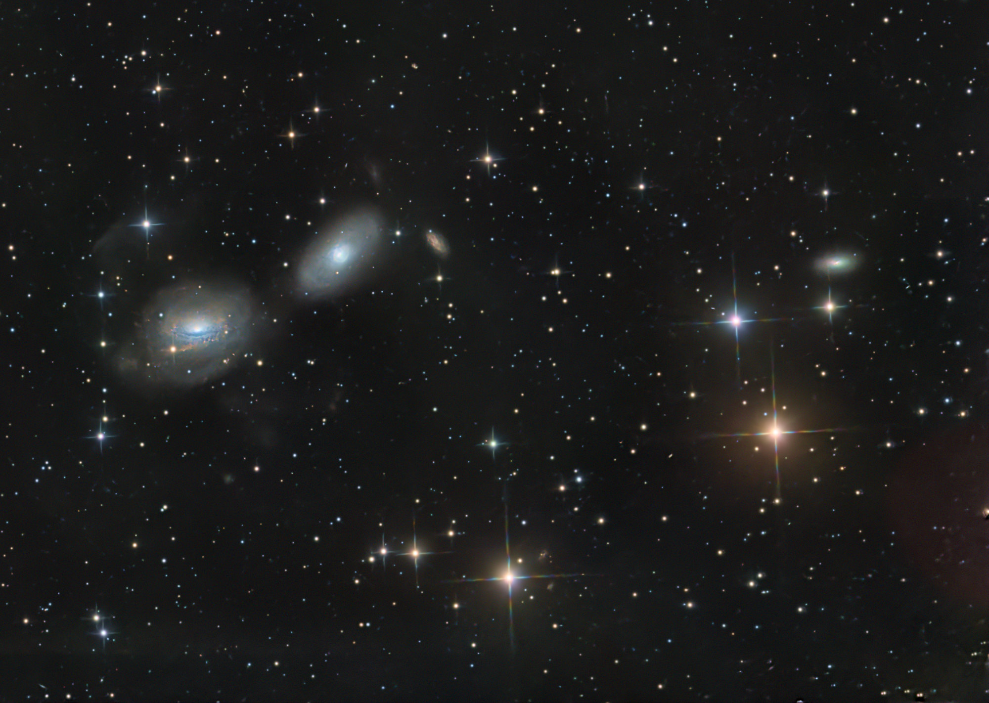 The spiral galaxy NGC 3169 on the left is about 70 million light-years away and is interacting with the neighboring galaxy NGC 3166. The two galaxies will eventually merge into one.
